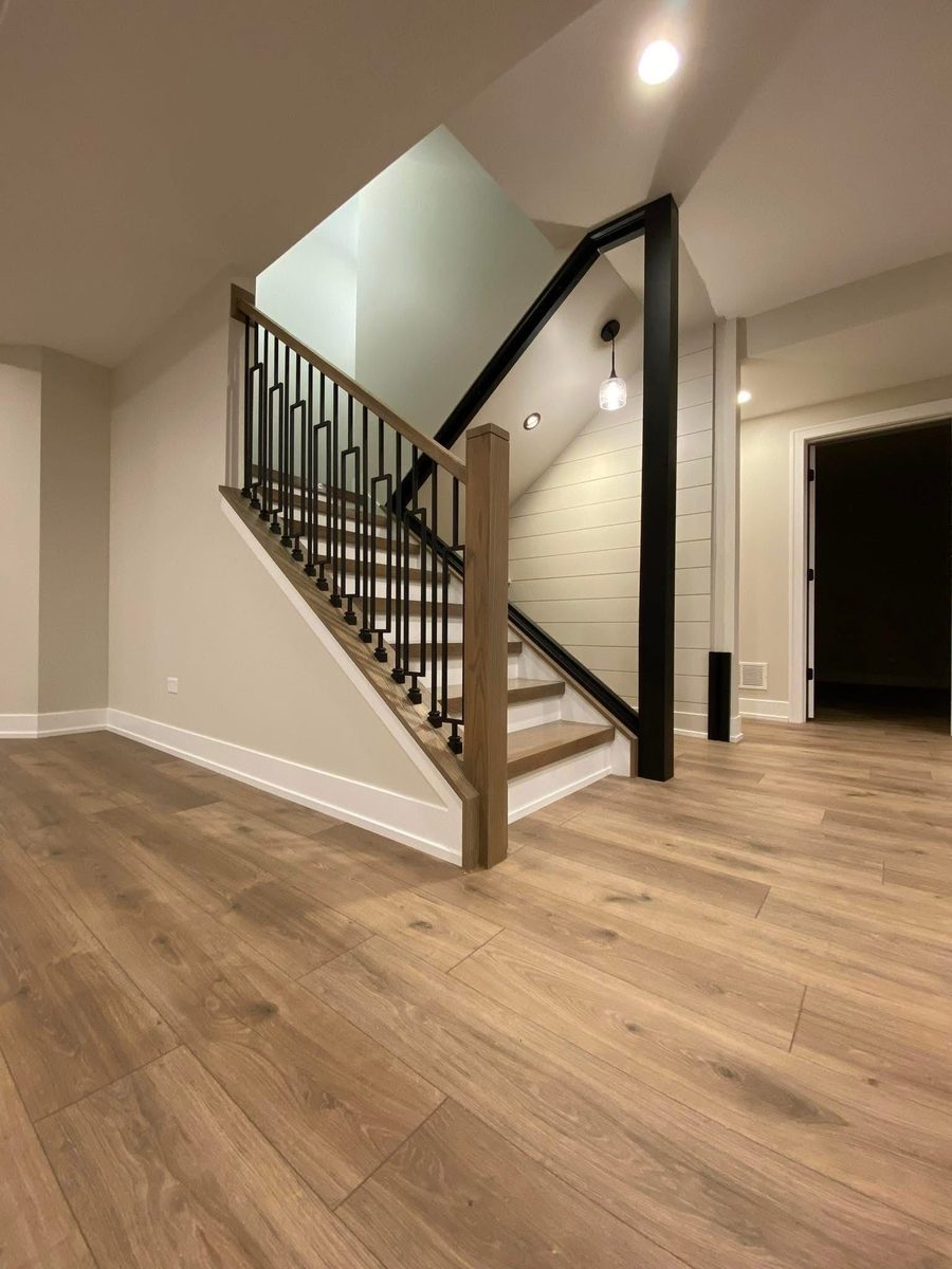 Luxury vinyl plank run through a stair landing, with the treads and the floor meeting cleanly at the nosing.